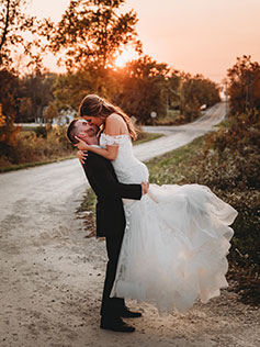 Groom picking up bride and kissing Groom picking up bride and kissing